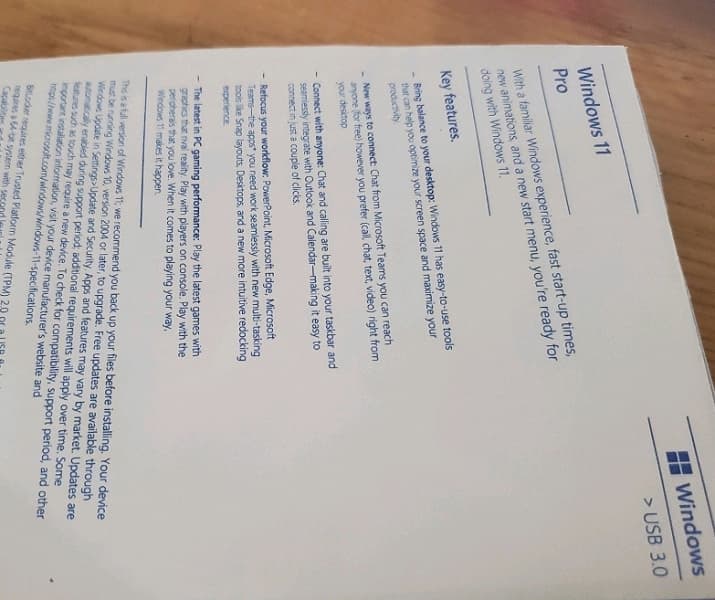 С новым меню Пуск в самом центре. На фото показали коробку Windows 11 Pro